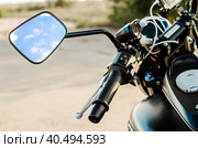 Reflection of the nab and clouds in the motorcycle mirror, motorcycle steering wheel and motorcycle fuel tank. Стоковое фото, фотограф Артем Курутин / Фотобанк Лори