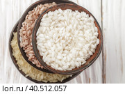 Set various organic raw rice on a wooden white table in ceramic bowls. Devzira. Arborio. Selective focus. Стоковое фото, фотограф Виктория Панченко / Фотобанк Лори
