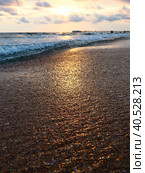 Sunset over sea. Beautiful sunset. Foamy waves roll over the sandy shore. Vityazevo, Anapa, Black Sea. Tourist mecca, health resort. Colorful clouds in the evening sky. Стоковое фото, фотограф Юлия Петровская / Фотобанк Лори