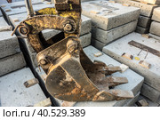 Excavator bucket lies on concrete blocks. Стоковое фото, фотограф Iva Noel / Фотобанк Лори