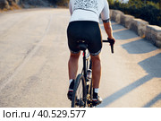 Close-up of men's sports ass in shorts riding a bicycle. Стоковое фото, фотограф Сергей Толмачёв / Фотобанк Лори