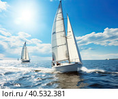 Luxury yachts on a sailing regatta. The bright sun is at its zenith. Sailing in the wind through the waves at sea. Bottom view from. Created by Ai. Стоковое AI-изображение, AI-художник Ярославский Максим / Фотобанк Лори