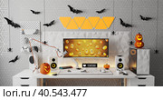 A general view of a gamer's home workplace with a computer and a gamepad decorated with decorations for the Halloween holiday. Стоковое фото, фотограф Енваев Андрей / Фотобанк Лори