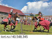 Two knights fight on spears at the festival of historical reconstruction "Russian Fortress" (2014 год). Редакционное фото, фотограф Анна Кривицкая / Фотобанк Лори