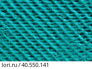 Uneven relief surface of green color with cracked paint. Abstract texture background. Close-up of a relief flat slate painted with green paint. Turquoise relief background. Стоковое фото, фотограф Александр Кротков / Фотобанк Лори
