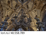 Czech Republic. Skulls and bones in the ossuary in Kutna Hora. Close up detailed view of Sedlec Ossuary, Church of Bones in Kutna Hora, decorated with real human skeleton bones. (2016 год). Редакционное фото, фотограф Анна Кривицкая / Фотобанк Лори