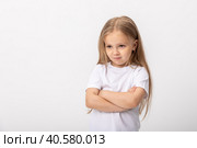 Negative human emotions, reactions and feelings. Isolated shot of moody displeased angry little girl crossing arms on her chest, pouting lips, having offended facial expression, being capricious. Стоковое фото, фотограф Ирина Михайличенко / Фотобанк Лори