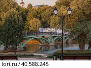 Summer evening Tsaritsyno Park in Moscow. View of the fountain and the church at sunset. Tsaritsyn Park is one of the main tourist attractions of Moscow. Russia, May 2023. Редакционное фото, фотограф Photojuli / Фотобанк Лори