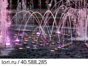 Light and music fountain on a summer evening. Natural Museum-reserve "Tsaritsyno". Colorful fountain in Tsaritsyno Park at night. (2023 год). Редакционное фото, фотограф Photojuli / Фотобанк Лори