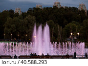 Light and music fountain on a summer evening. Natural Museum-reserve "Tsaritsyno". Colorful fountain in Tsaritsyno Park at night. (2023 год). Редакционное фото, фотограф Photojuli / Фотобанк Лори