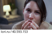 woman covering her face with her palms raises her head and looks at the camera. Стоковое видео, видеограф Денис Кебедов / Фотобанк Лори