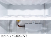Freezer compartment with frozen ice and evaporator, selective focus. Defrost fridge and freezer. Стоковое фото, фотограф Коханова Наталья / Фотобанк Лори