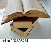 A stack of old books on a light surface. Books are shifted relative to each other. The top book is open. Стоковое фото, фотограф Бузмакова Светлана / Фотобанк Лори