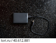 External HDD WD Elements Portable in a black case with a wire on a black background. A useful portable storage device, a portable device with a high data transfer rate. Стоковое фото, фотограф Коханова Наталья / Фотобанк Лори