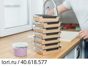 food containers are stacked on the kitchen counter. Стоковое фото, фотограф Bogdanova Mariia / Фотобанк Лори