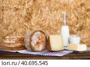 whole head of ripe country cheese and slices and milk in hayloft. Стоковое фото, фотограф Татьяна Яцевич / Фотобанк Лори