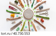 Video of hand embroidery. Circular composition of accessories for cross stitch: hoop with canvas, scissors, set of needles, skeins of cotton threads in natural colors, pins. Flat lay, close-up, top view. Стоковое видео, видеограф Виктория Катьянова / Фотобанк Лори