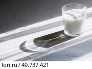 Organic probiotic milk kefir drink or yogurt in glass containers,on the white grey background. Gut health. Probiotic cold fermented dairy drink. Trendy food and drink. Shadow trend Copy space. Стоковое фото, фотограф Tatiana Syrtseva / Фотобанк Лори