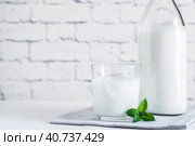 Organic probiotic milk kefir drink or yogurt in glass containers,on the white grey background. Gut health. Probiotic cold fermented dairy drink. Trendy food and drink. Copy space. Стоковое фото, фотограф Tatiana Syrtseva / Фотобанк Лори