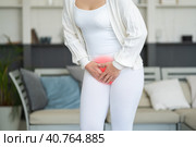 Menstrual pain, woman with stomachache suffering from pms at home, endometriosis, cystitis and other diseases of the urinary system. Стоковое фото, фотограф Станислав Тарко / Фотобанк Лори