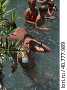Pammukale, Turkey - July, 19, 2015: People in antique Cleopatra's pool with thermal water in ancient city Hierapolis, near modern Turkey city Denizli. Редакционное фото, фотограф Анна Кривицкая / Фотобанк Лори