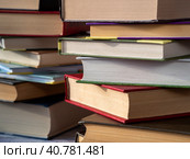 Books of various thicknesses and with various covers are stacked. Close-up. Background for libraries, education, scientific work. Стоковое фото, фотограф Бузмакова Светлана / Фотобанк Лори
