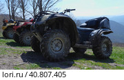 Dirty quad bikes stand against the backdrop of mountain peaks. Extreme type of outdoor activities. ATV touring trip. Стоковое фото, фотограф Воловодов Владимир / Фотобанк Лори