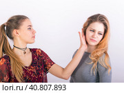 Two young woman fighting, a slapping in the face. Стоковое фото, фотограф Сергей Сергеев / Фотобанк Лори
