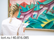 HAMBURG, GERMANY - 9 JULY 2017: Hamburg Kunsthalle art museum. Jung woman in front of painting. Редакционное фото, фотограф Igor Tichonow / Фотобанк Лори
