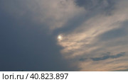 Cirrus clouds cover the disk of the sun with clouds. The disappearance of the sun behind thick dark clouds. Sunbeams in the haze. Sunset for Halloween. Weather forecast. Sky background. Стоковое видео, видеограф Юлия Петровская / Фотобанк Лори