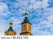 Orthodox Church building with golden domes and crosses against the background of the sky and clouds. Church of St. Sergius of Radonezh, city of Magadan, Magadan Region, Russian Far East, Siberia. Стоковое фото, фотограф Андрей Степанов / Фотобанк Лори