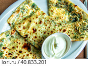 Delicious gourmet flat bread kutabs with herbs and cheese on a plate. Стоковое фото, фотограф Евгений Ткачёв / Фотобанк Лори
