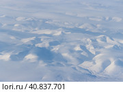 Aerial view of snow-capped mountains and clouds. Winter snowy mountain landscape. Icheghem Range, Kolyma Mountains. Koryak Okrug (Koryakia), Kamchatka Krai, Siberia, Far East Russia. Great background. Стоковое фото, фотограф Андрей Степанов / Фотобанк Лори