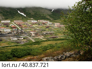 Gudym, Chukotka, Far East Russia - June 30, 2007. The abandoned arctic military town of Gudym in the tundra among the mountains. It was built during the Cold War. Abandoned in 2002. Demolished in 2017. Редакционное фото, фотограф Андрей Степанов / Фотобанк Лори