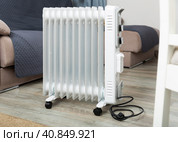 Electric oil heater on floor in room. Стоковое фото, фотограф Яков Филимонов / Фотобанк Лори