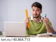 Young male student physicist sitting in the classroom. Стоковое фото, фотограф Elnur / Фотобанк Лори