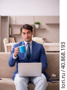 Young male employee working from home during pandemic. Стоковое фото, фотограф Elnur / Фотобанк Лори