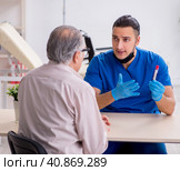 Old patient visiting young male doctor in blood sampling concept. Стоковое фото, фотограф Elnur / Фотобанк Лори