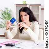 Young woman with receipts in budget planning concept. Стоковое фото, фотограф Elnur / Фотобанк Лори