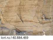 Sandstone is a fragmentary sedimentary rock, a homogeneous or layered aggregate of fragmentary grains and grains of sand bound by any mineral substance, cement. Quarry natural yellow sand wall. Стоковое фото, фотограф Юлия Петровская / Фотобанк Лори