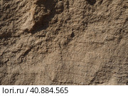 Sandstone is a fragmentary sedimentary rock, a homogeneous or layered aggregate of fragmentary grains and grains of sand bound by any mineral substance, cement. Quarry natural yellow sand wall. Стоковое фото, фотограф Юлия Петровская / Фотобанк Лори