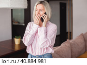 middle-aged woman holding phone, reading unpleasant news in social media. Стоковое фото, фотограф Гладских Татьяна / Фотобанк Лори