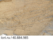 Sandstone is a fragmentary sedimentary rock, a homogeneous or layered aggregate of fragmentary grains and grains of sand bound by any mineral substance, cement. Quarry natural yellow sand wall. Стоковое фото, фотограф Юлия Петровская / Фотобанк Лори