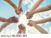 Joined hands as a team. Business teamwork. Close up group of friends meeting join hands together. Diversity people. Partnership volunteer community. Diverse multiethnic Partners. Blue Sky background. Стоковое фото, фотограф Марина Демидюк / Фотобанк Лори