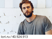 Expressive young bearded man scared and nervous. Стоковое фото, фотограф Сергей Толмачёв / Фотобанк Лори