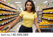 Attractive young latino woman working in a supermarket, wearing a yellow shirt and dark trousers. Caucasian girl owning small business posing looking at the camera with hand crossed. Business concept. Стоковая иллюстрация, иллюстратор Sergey Grishin / Фотобанк Лори