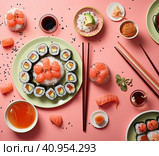 Smooth laying out of various sushi rolls on plates with chopsticks on the table. Created by AI. Стоковое AI-изображение, AI-художник Ярославский Максим / Фотобанк Лори