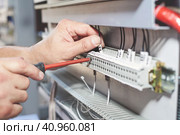 The electrician performs the installation and configuration of high-voltage equipment. Стоковое фото, фотограф Стас Пересыпкин / Фотобанк Лори