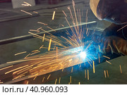 Man processes metal with gas electric welding. Стоковое фото, фотограф Стас Пересыпкин / Фотобанк Лори