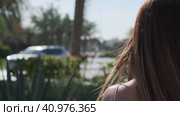 Close-up of long hair of a young girl walking through a tropical garden. Стоковое видео, видеограф Aleksey Kidisyuk / Фотобанк Лори